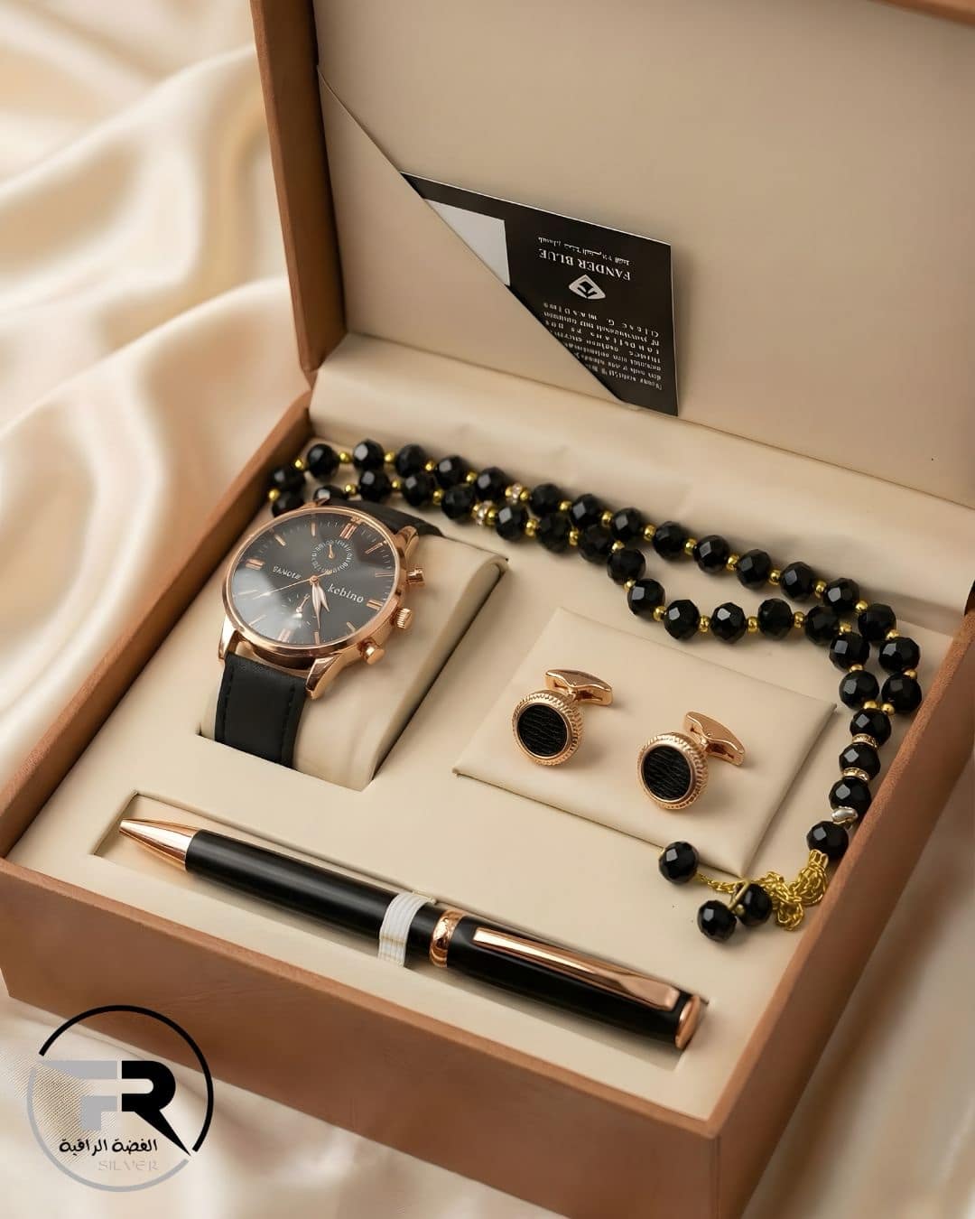 mens-luxury-gift-set-rose-gold-watch-pen-cufflinks-misbaha A premium men's gift set featuring a rose gold chronograph watch with a black leather strap, matching cufflinks, a sleek black and rose gold executive pen, and a black beaded prayer rosary (Misbaha), all presented in a luxury wooden box