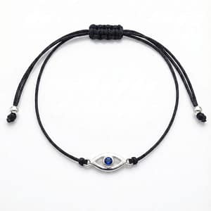 A minimalist adjustable black cord bracelet for women and kids, featuring a silver-rimmed evil eye charm with a vibrant blue crystal center for protection and style