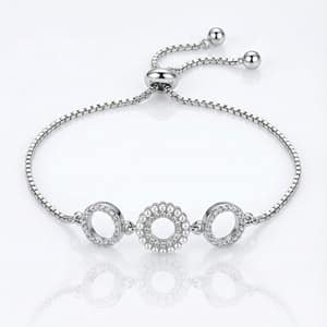 An elegant 925 Sterling Silver bolo bracelet featuring three interconnected circular motifs: a central circle rimmed with small white pearls and two side circles set with sparkling cubic zirconia, on an adjustable box chain