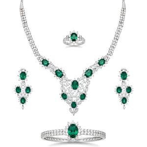 A Stunning 925 Sterling Silver Jewelry Set for Women featuring Vibrant Oval-cut Emerald Green Gemstones surrounded by Sparkling White Zirconia, including a Grand Necklace, Bracelet, Ring, and Dangle Earrings